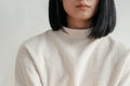 Detail of a cream knit cotton sweater