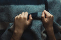 Hands holding a thick cozy weighted blanket